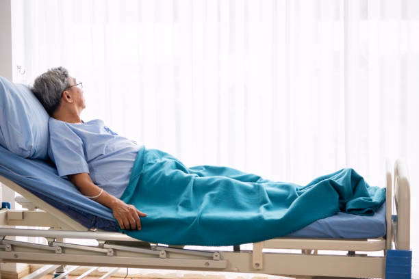 What does a man hold a woman hand in a hospital bed do?