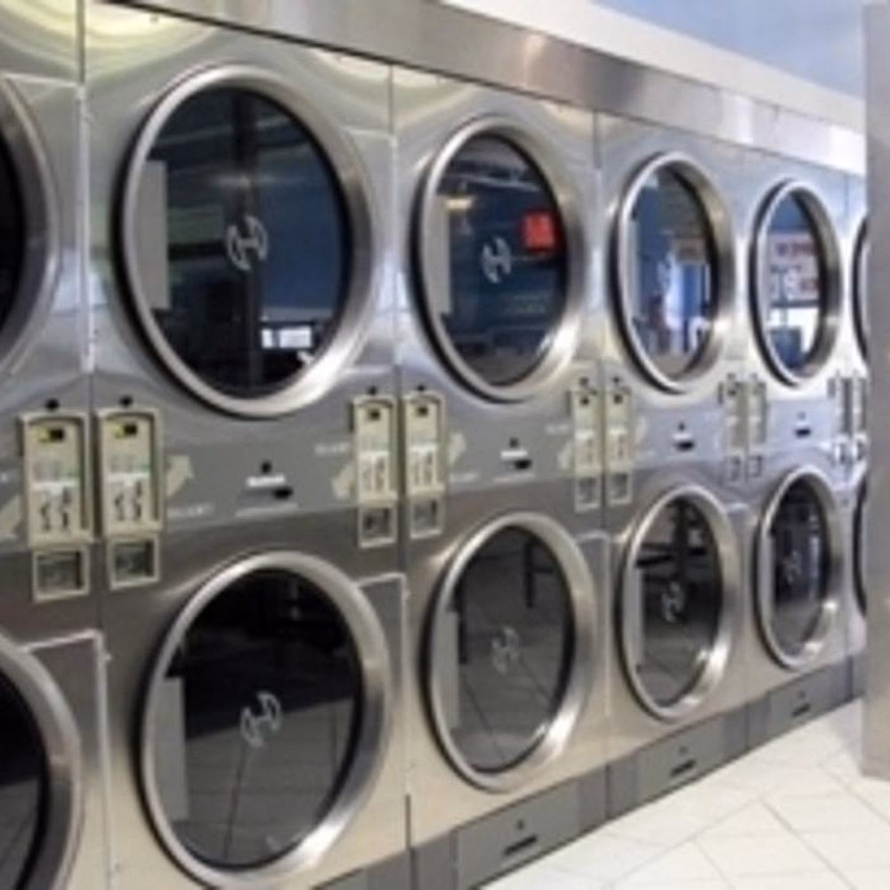 How can I find a coin laundry in a different city?